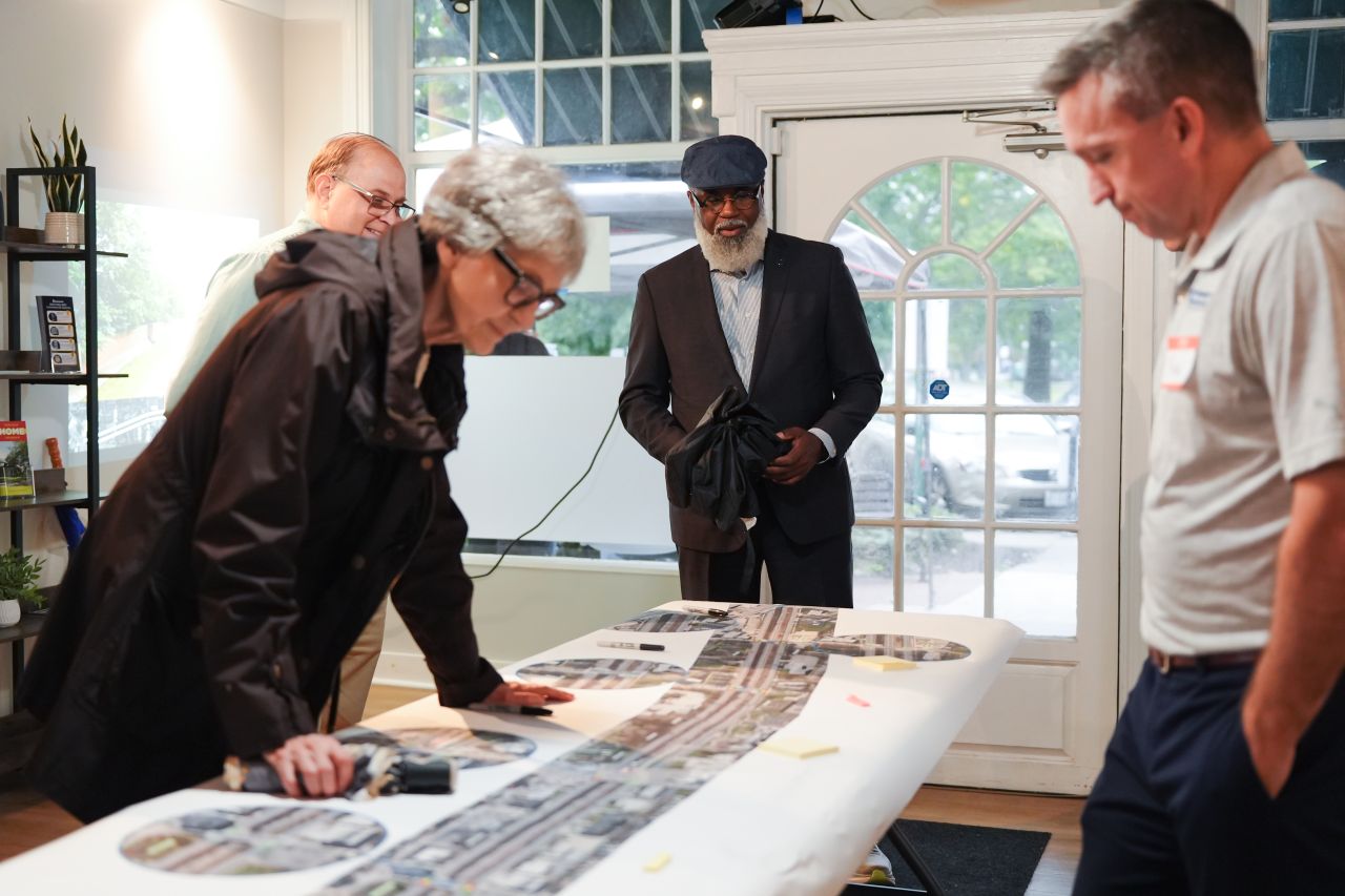 Photo of residents and project team members looking at a map of the Shaker Boulevard corridor and the proposed changes.