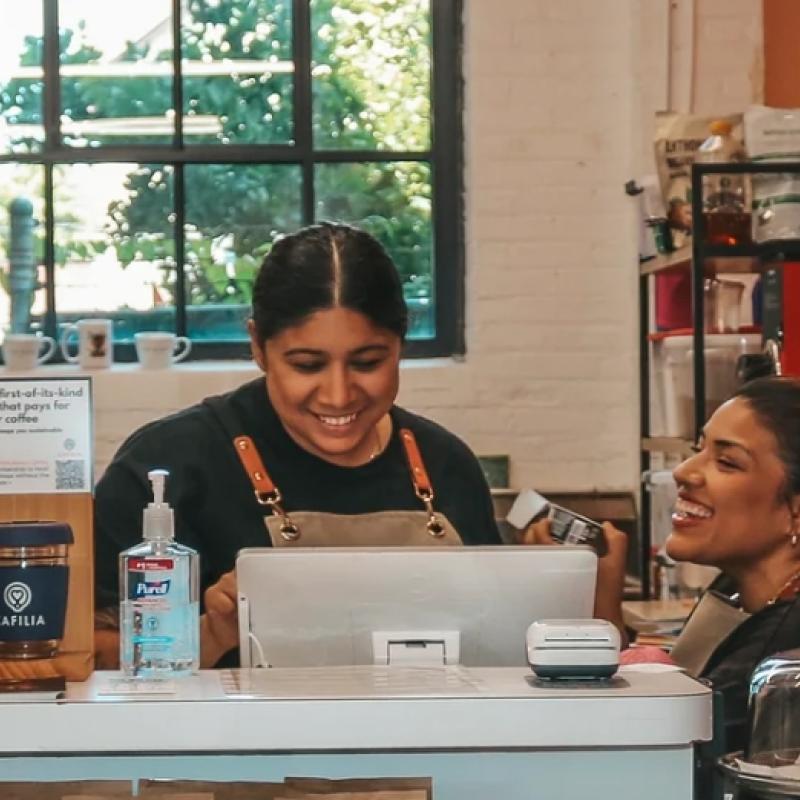 Three people working behind the counter at Dahlia Coffee Co. 