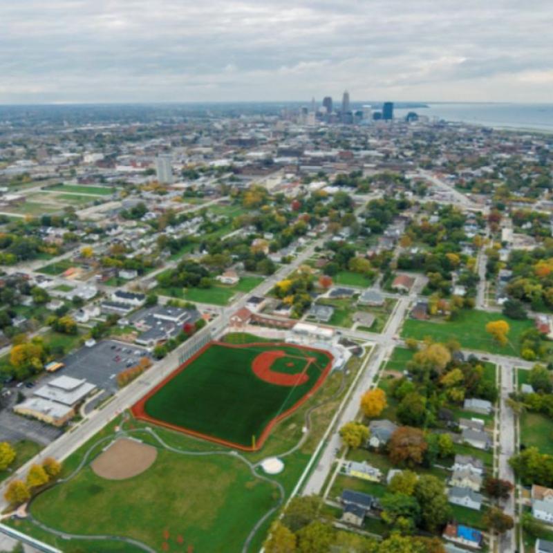 Aerial sky view of East 66th Street showing the Baseball Heritage Park Field and Downtown Cleveland in distance