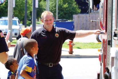people enjoy cold treats outside a fire truck 