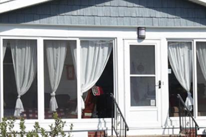 front of a home with curtains