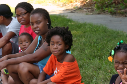 group of children sitting on grass