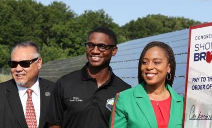 3 people next to oversize check