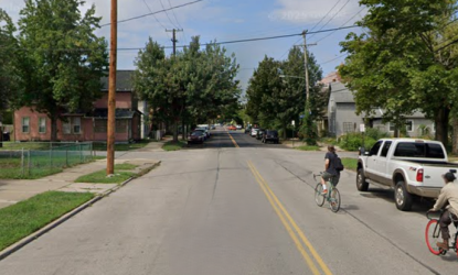 A street view on Bridge Avenue shows vehicles parked on one side and people biking down the street.