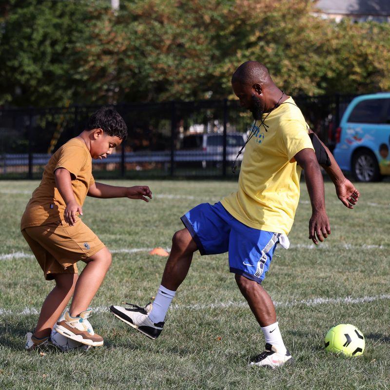 two people playing soccer
