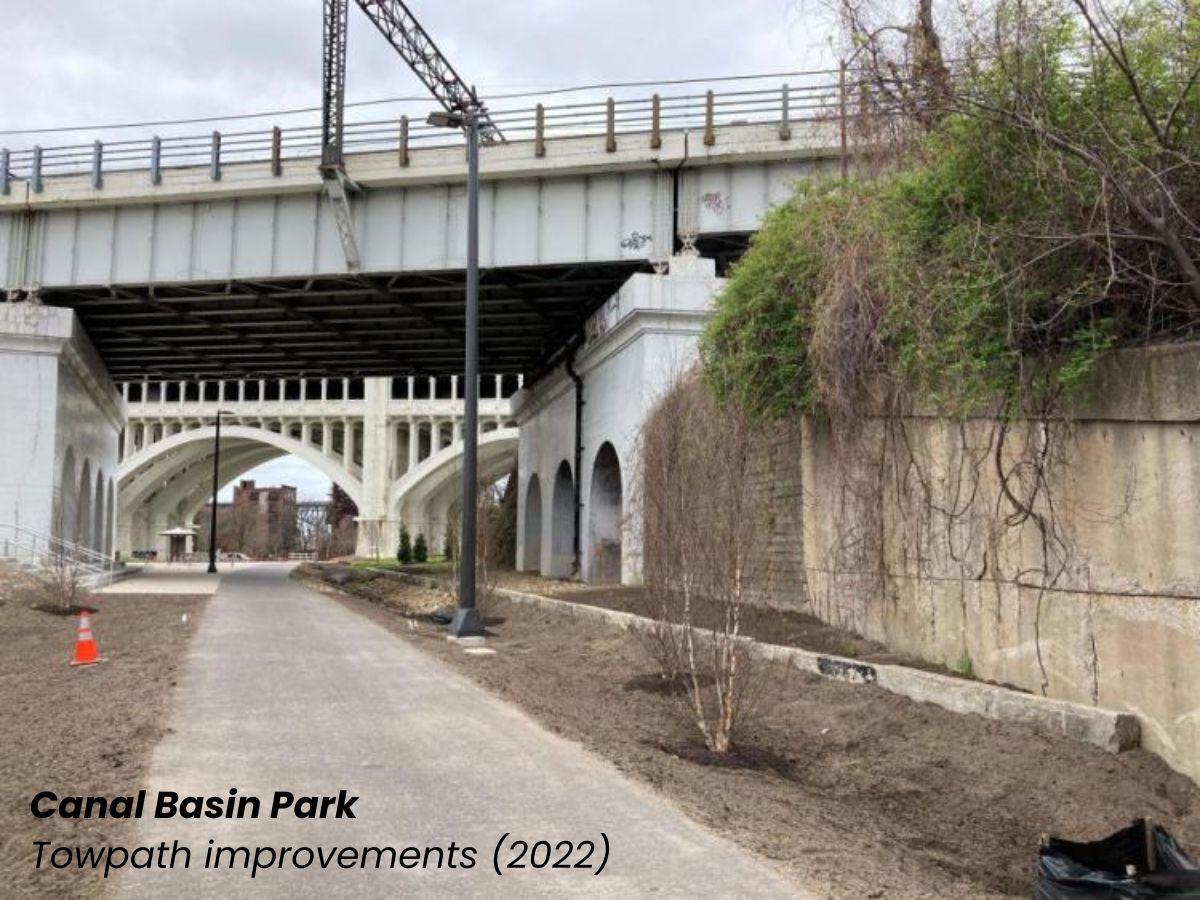 Canal Basin Park towpath improvements showing the new trail pavement under a bridge.