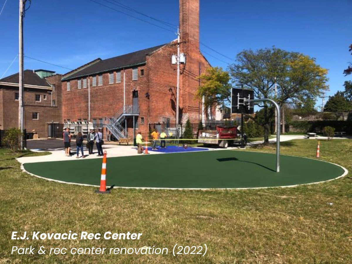 E.J. Kovacic Rec Center park and rec center renovation showing a green half basketball court with the brick building behind it.