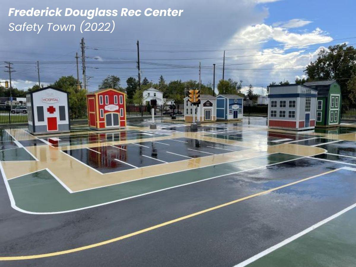 Frederick Douglass Rec Center new safety town in the parking lot with small buildings and a miniature painted road for children.