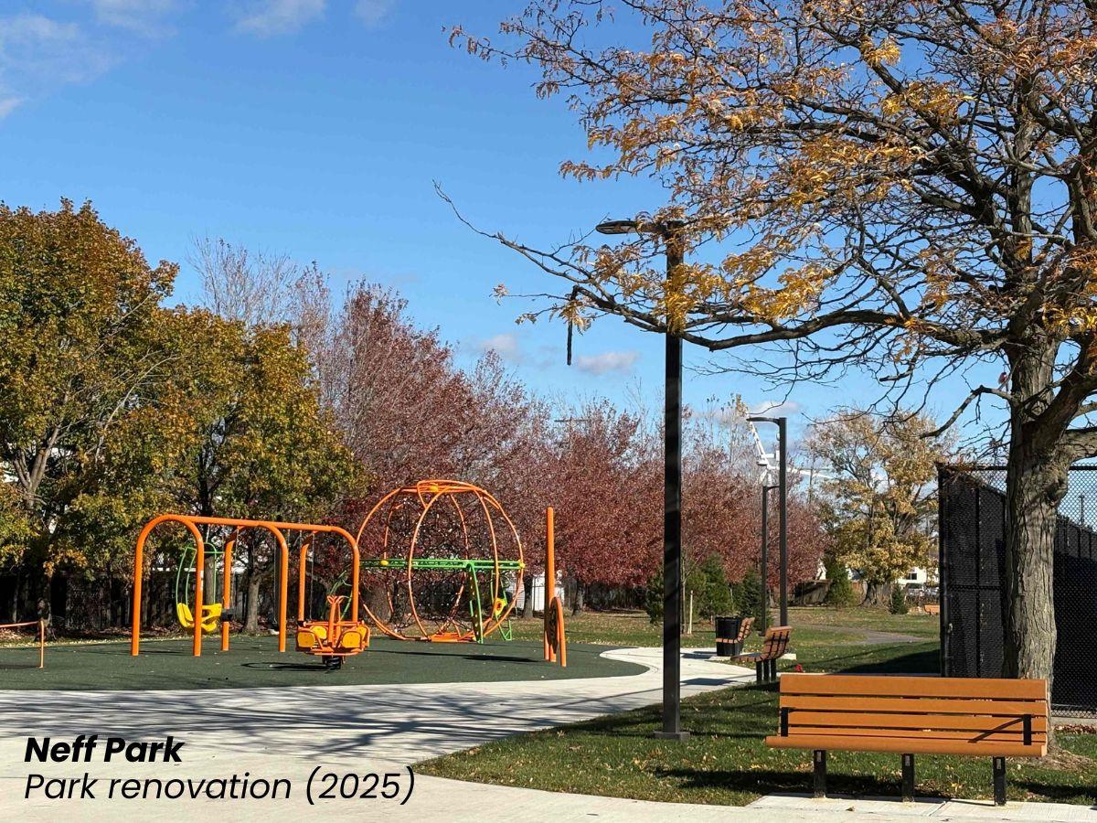 A modern orange playground with a walking path and bench next to it.