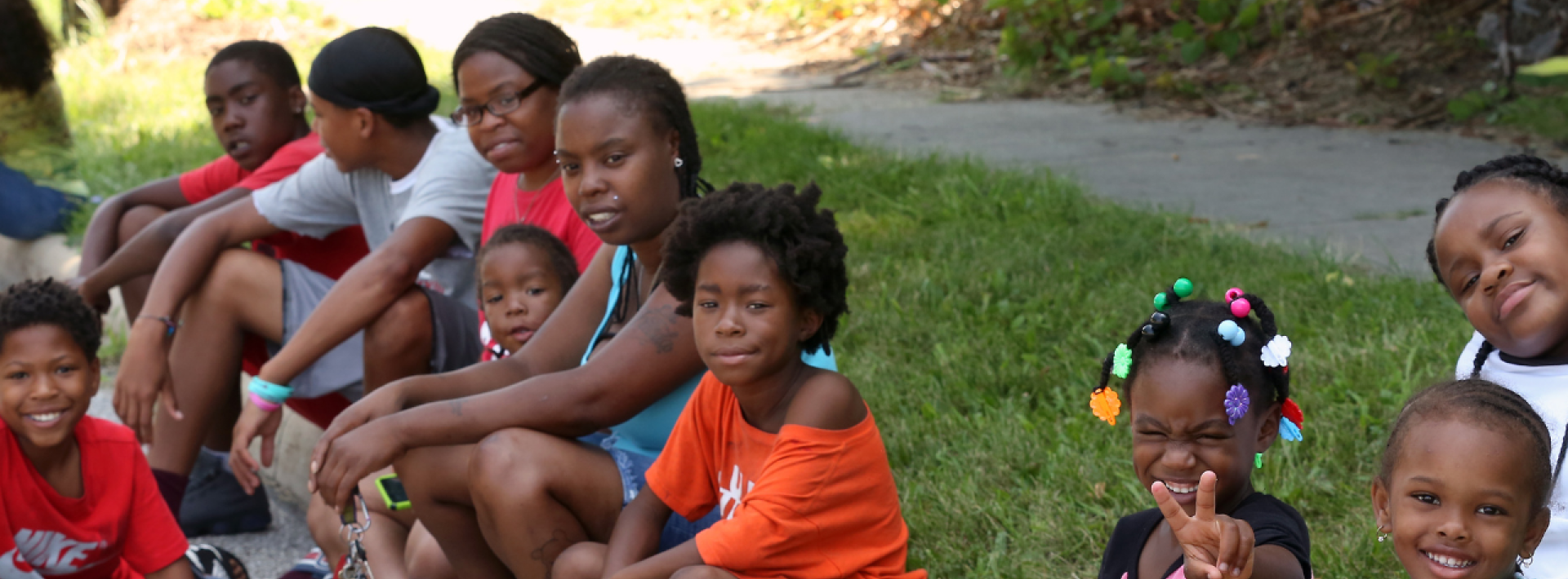 group of children sitting on grass