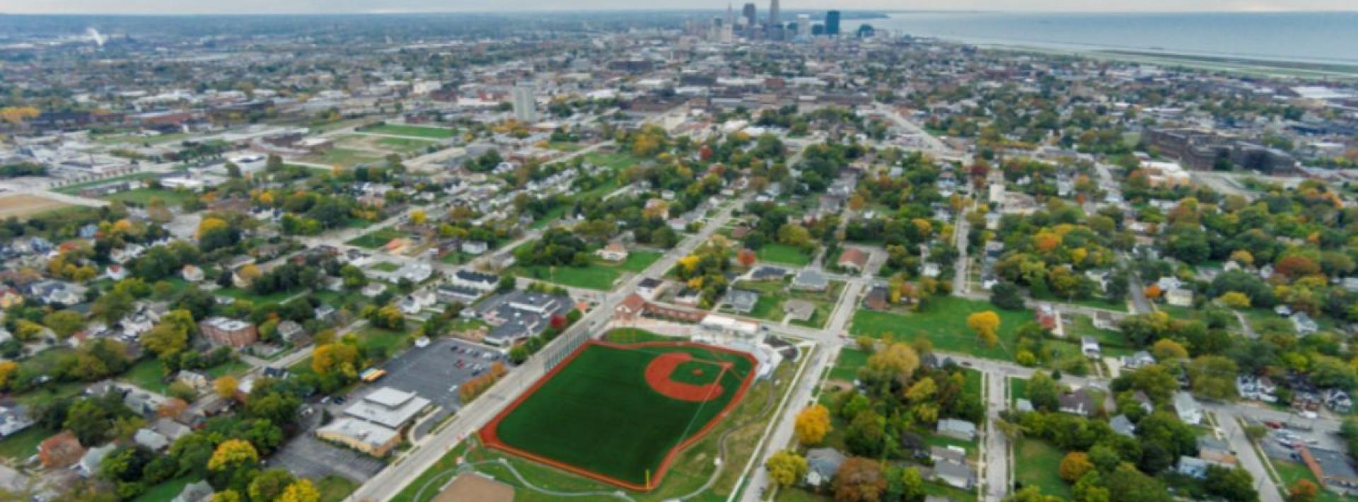 Aerial sky view of East 66th Street showing the Baseball Heritage Park Field and Downtown Cleveland in distance