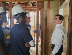 construction workers looking at interior wall project