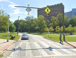 An example of a crosswalk with an overhead rectangular rapid flashing beacon at the Nord Family Greenway in University Circle.