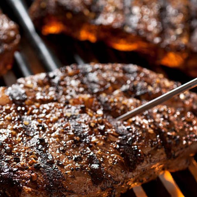 hamburger on grill with temperature gauge