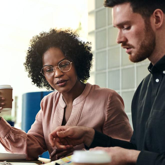 Man and woman looking at finances at table