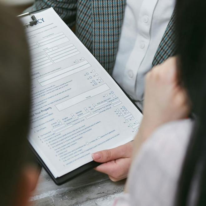 Advocate reviewing document with couple