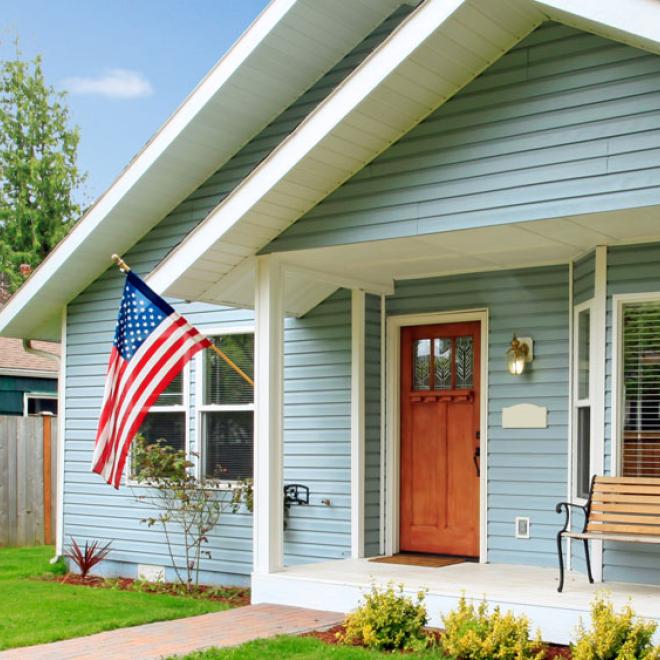 front porch of cute house with a flag hanging