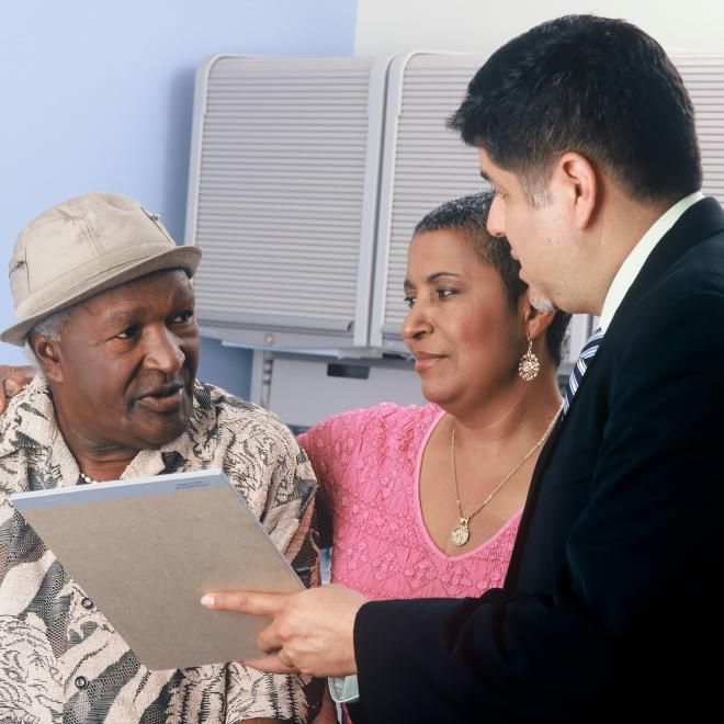 Three individuals looking at each other discussing a topic.